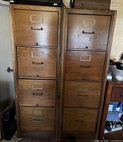 Front view of two oak 4-drawer file cabinets side by side