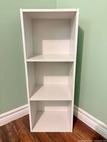 Front full view of white three-compartment bookcase
