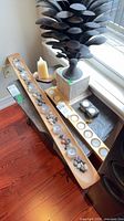 Full lot overview showing wood tealight tray, gold metal tealight holder, stone sculpture and candles