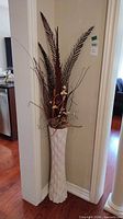 Full view of faux plant arrangement placed in corner