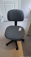 Front view of gray armless swivel office chair