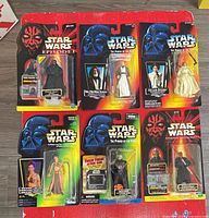 Group shot of all six sealed Star Wars figures on cards