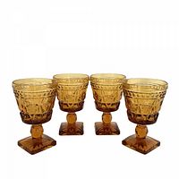 Four amber Park Lane wine goblets front view
