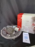 Clear glass bowl with snowflake design shown beside original Studio Nova box