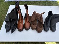 Group shot of all four pairs of boots on table