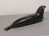 Full left-side view of soapstone walrus sculpture