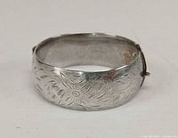 Front view showing engraved floral design on bracelet