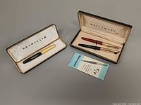 Both Waterman cases open showing three pens and pamphlet