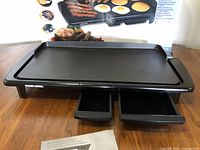 Top view of griddle with warming trays extended
