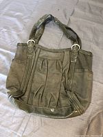 Front view of olive green suede and leather purse
