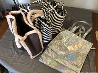 Assorted reusable bags laid out on table surface