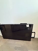Front view of Samsung flat screen TV with remote on top