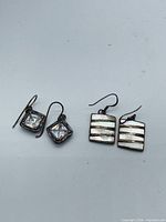 Both earring pairs side by side showing overall style and scale
