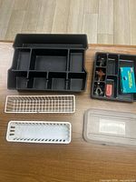 Overall view of all organizers, trays, basket, accessory tray contents and separate lid