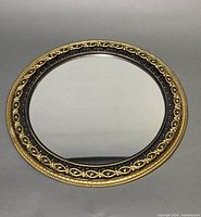 Front view showing entire round mirror and decorative frame