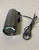 Overall view of LED pinspot with plug and cord visible