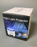 sealed retail box displaying product graphics and Night Light Projector text