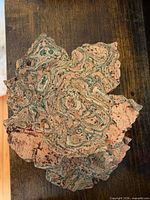 Stack of maple leaf cork coasters showing marbled topside