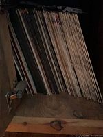 Side view of stacked vinyl LPs on shelf