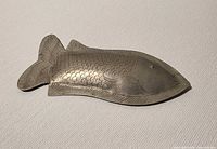 Front view showing fish design and engraved details
