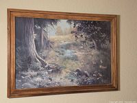 Front view showing entire framed landscape painting
