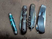 Four closed pocket knives lined up