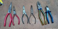 Six assorted pliers laid out side by side