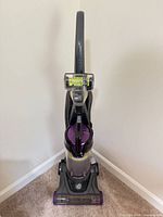 Front view of the upright vacuum showing overall condition and color scheme