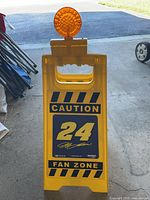 Front view of yellow A-frame sign with #24 Jeff Gordon graphics and amber light