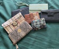 Group shot of all six wallets on green background