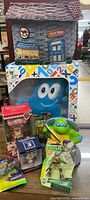 Full group shot of all seven items including Rosenthal basket, Expo plush box, three boxed figures and two TMNT packages