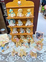 Full view of wooden rack with 12 calendar figurines and additional figurines on table
