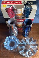 Group shot showing both vases, two pressed glass pieces and boxed hot cups