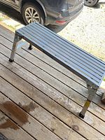 Side view of full aluminum work platform with legs extended