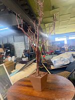 Full view of artificial tree in pot on table