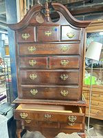 Front view of highboy showing overall design, drawers, pediment and legs