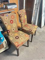 Both floral upholstered Parsons chairs front three-quarter view