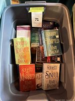 Top view of plastic tote showing Mary Balogh titles and other paperbacks