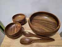 Entire 7-piece acacia wood set: large bowl, four small bowls, two spoons