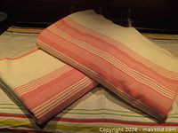 Both flannel sheets folded showing pink stripe pattern