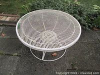Top view of round white mesh metal table
