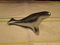 Right side profile of brushed aluminum seal sculpture