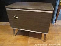 front view of vinyl sewing basket showing starburst motif and lid