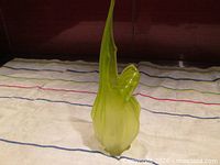 Full view of lime green art glass vase showing tall pulled rim and bulbous base