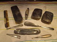 Full layout of all ten sterling grooming pieces on cloth