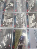 Nine trading cards in 9-pocket binder page, front views visible
