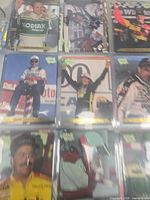 Nine sleeved NASCAR base cards, upper row of binder page