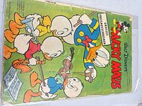Full front cover of Micky Maus comic showing characters and wear