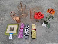 Entire lot laid out including baskets, placemats, canister, framed print and artificial flowers