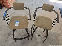 Two metal frame bar stools with upholstered seats and backs